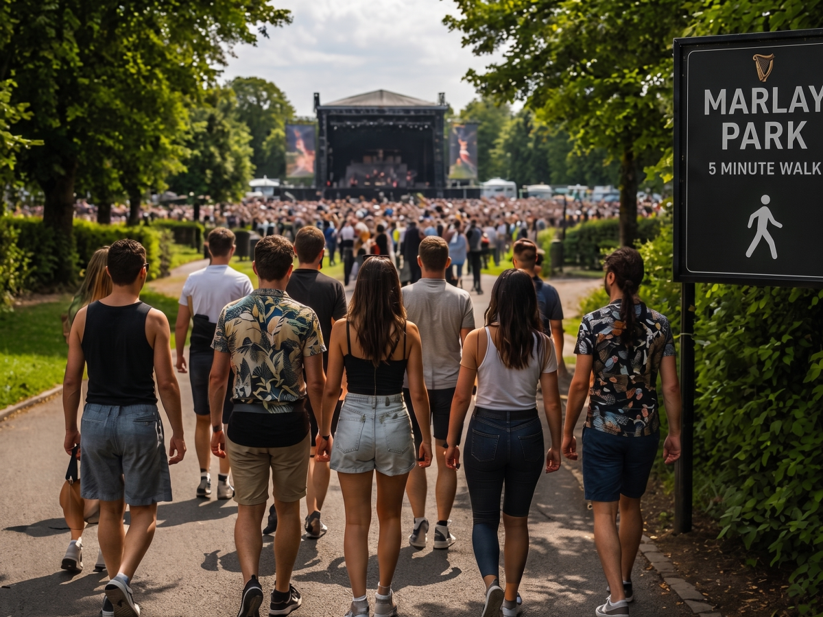 Group walking towards outdoor concert at Marlay Park on a sunny day.